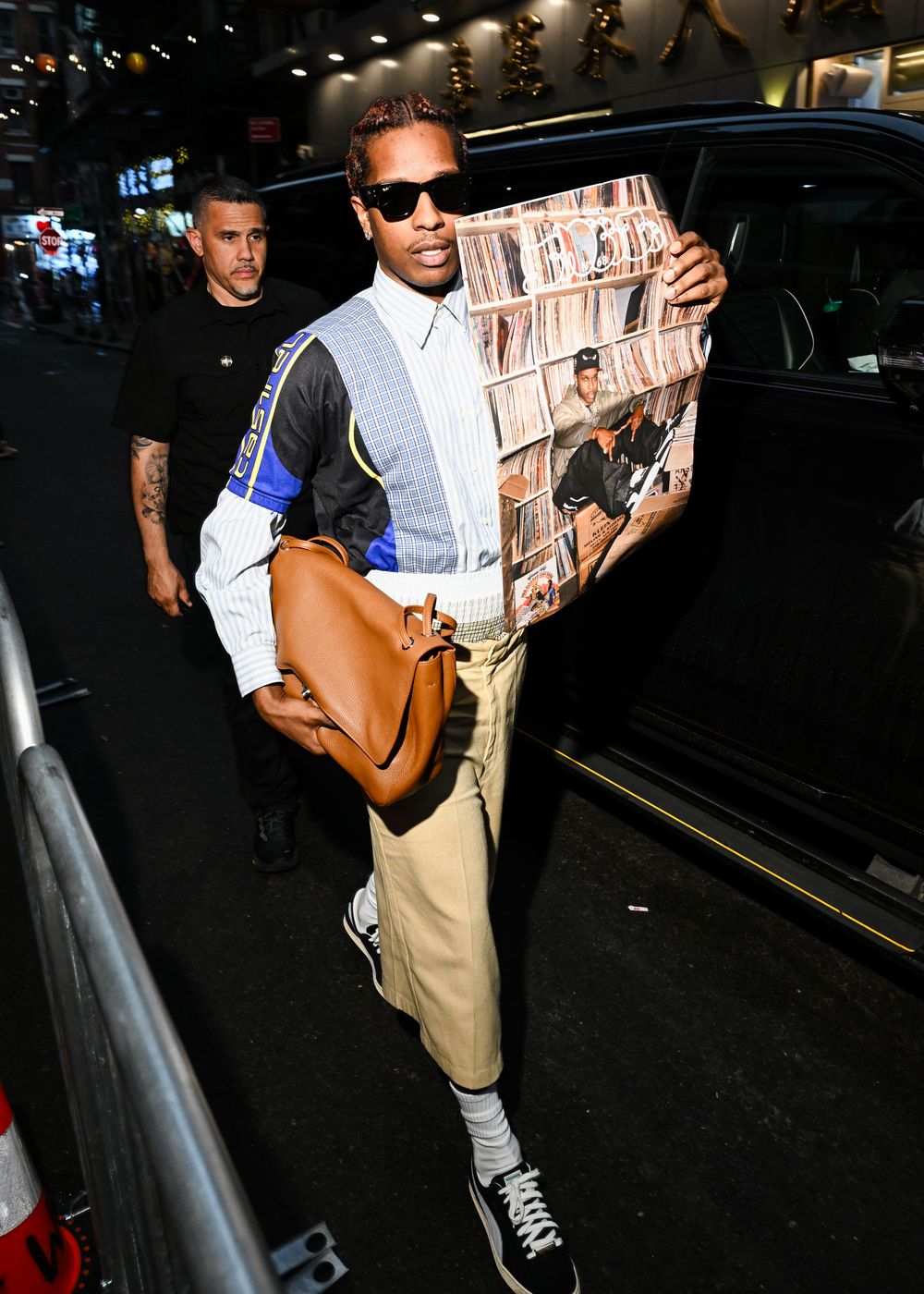 A$AP Rocky arriving on Pell Street carrying the poster