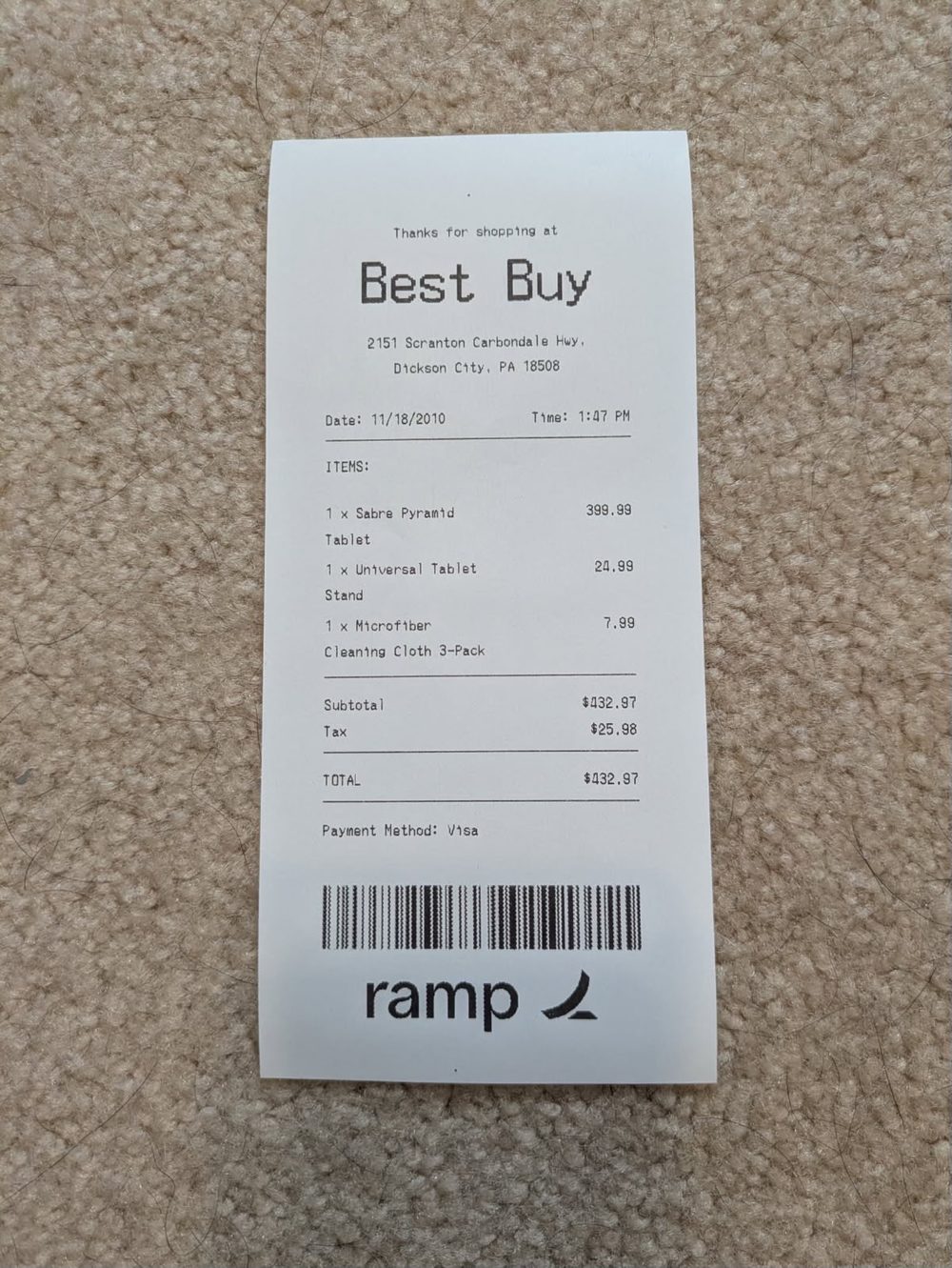 A printed receipt with the Ramp logo and barcode