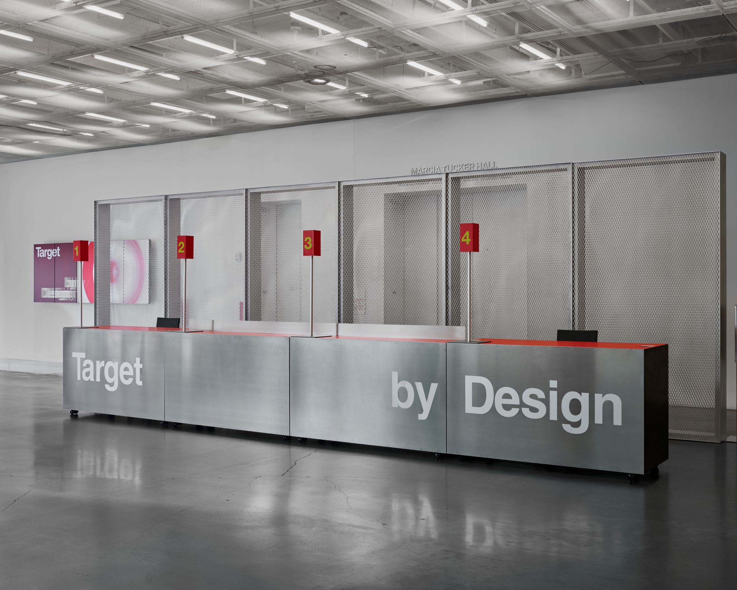 The Target by Design front desk, four numbered check-in stations in the museum lobby