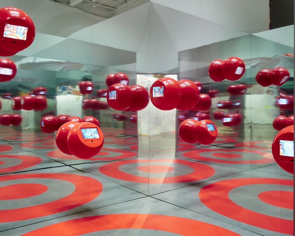A mirrored room of red bullseye spheres